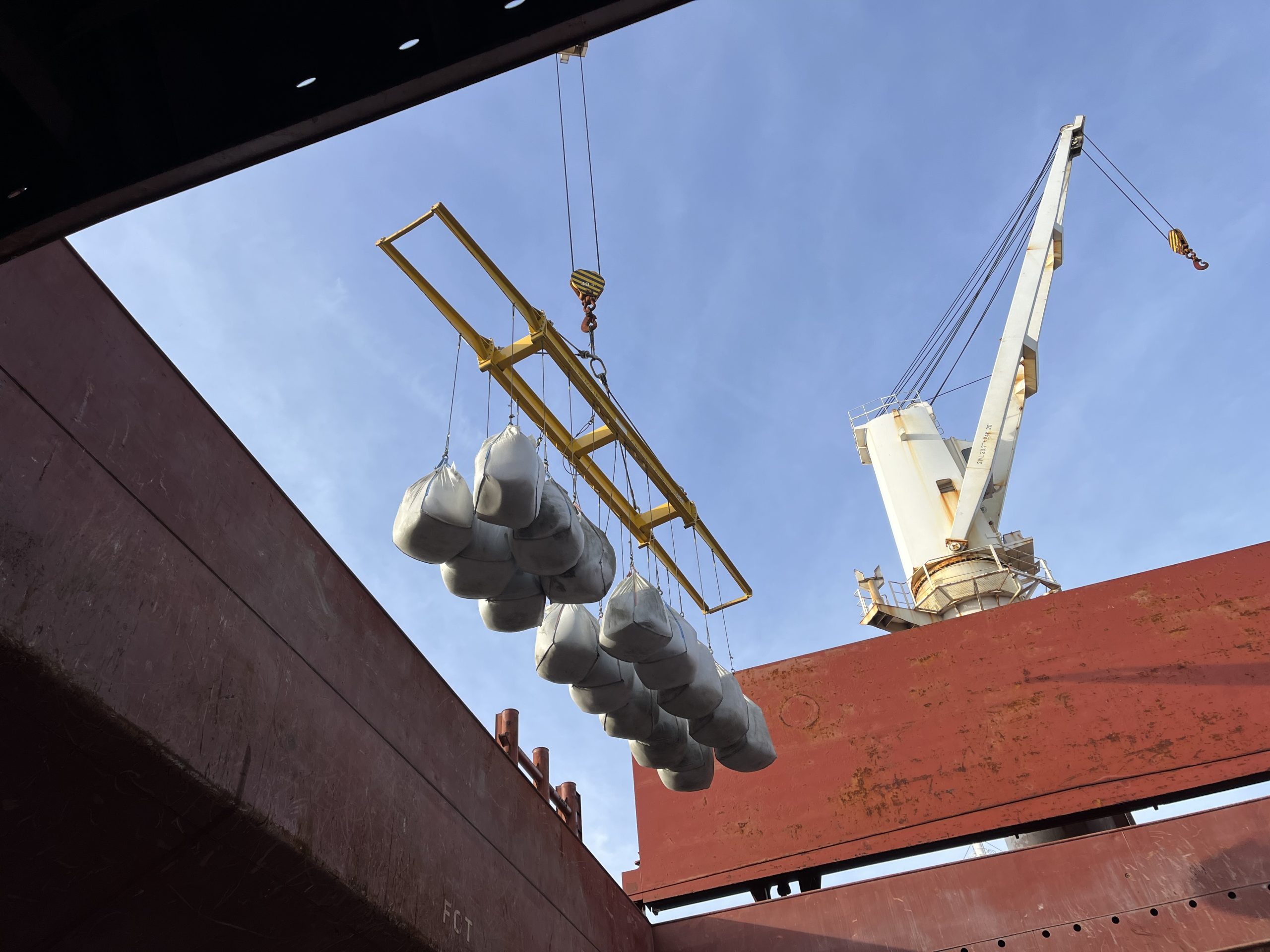 Crane putting cargo on ship